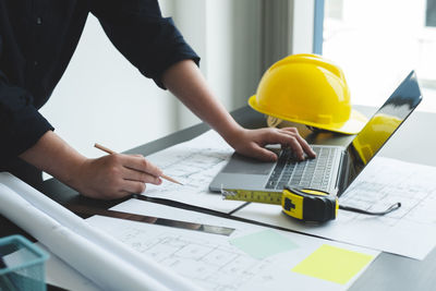 Midsection of businessman working at office