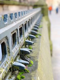 Close-up of railing on footpath