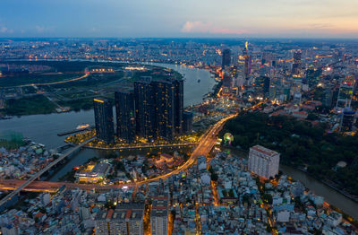 High angle view of illuminated city buildings against sky