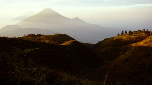 Scenic view of mountains against cloudy sky