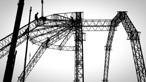 Low angle view of electricity pylon against clear sky