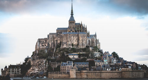 Historic building against cloudy sky