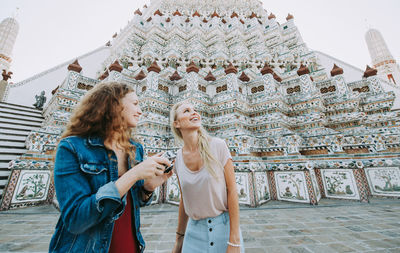 Happy women at temple in city