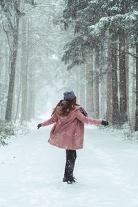 Rear view of woman on snow covered land