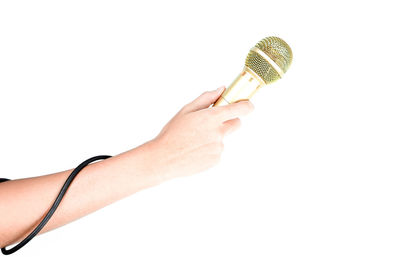 Close-up of hand holding ice cream over white background