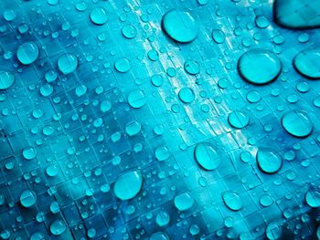 Close-up of water drops on plastic tarp