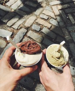 High angle view of hands holding ice cream