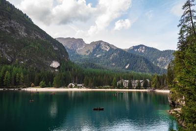 Scenic view of lake by mountains against sky