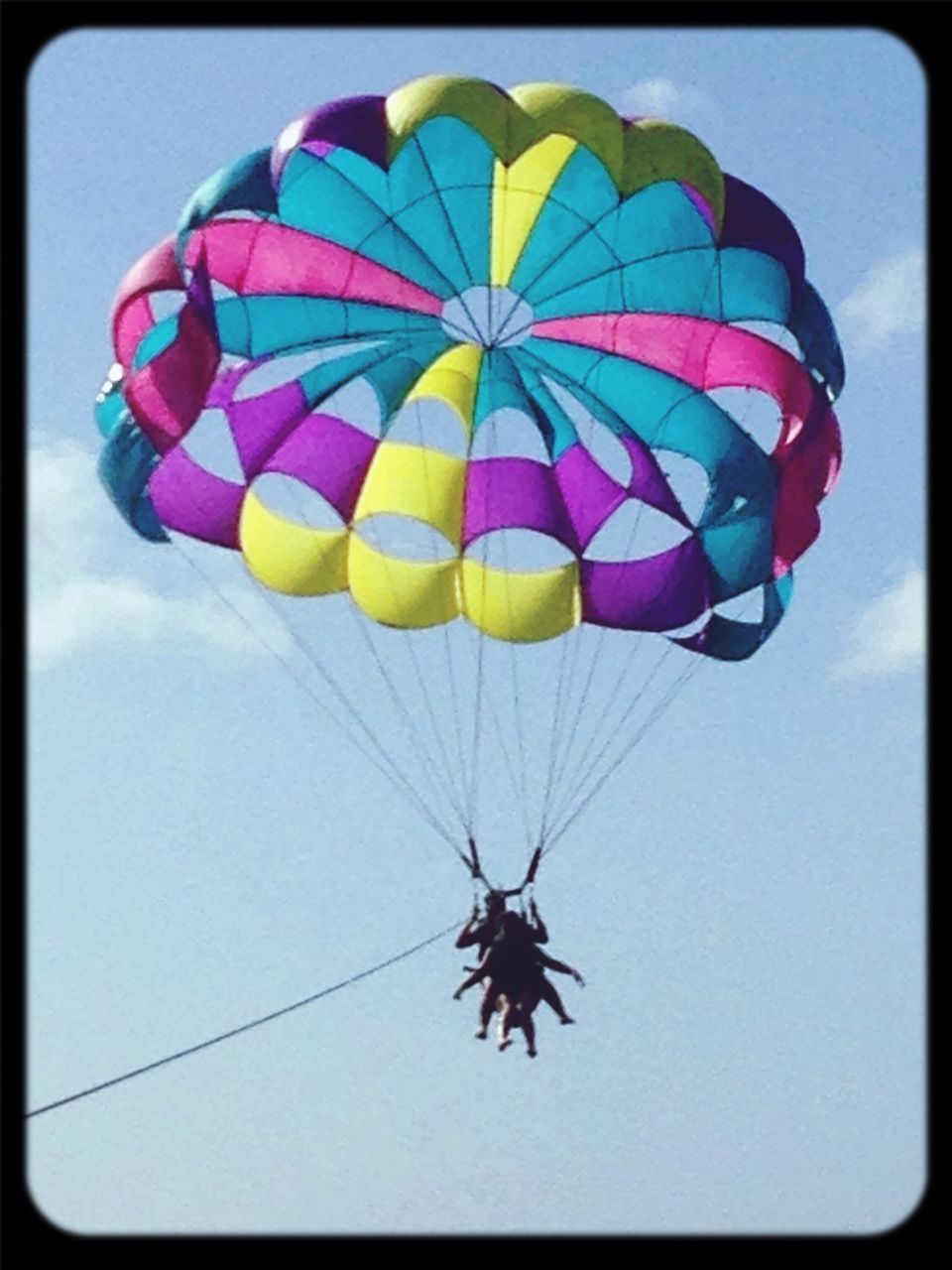 low angle view, transfer print, multi colored, auto post production filter, mid-air, flying, sky, parachute, blue, leisure activity, hot air balloon, day, fun, outdoors, adventure, extreme sports, transportation, amusement park, no people, amusement park ride