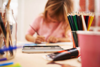 Midsection of woman using laptop on table