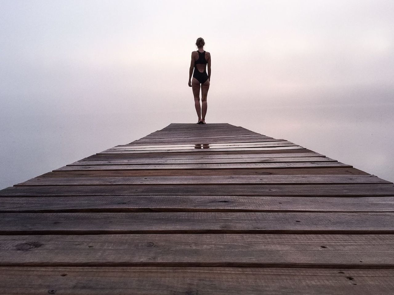 full length, lifestyles, leisure activity, casual clothing, standing, steps, sky, wood - material, rear view, men, the way forward, walking, pier, railing, built structure, sea, day, staircase