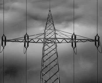 Low angle view of electricity pylon against sky