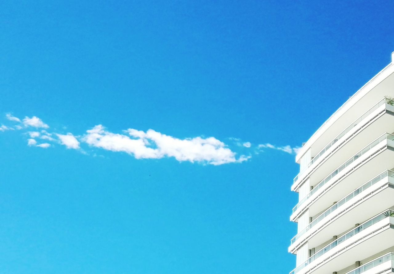 LOW ANGLE VIEW OF BUILDINGS AGAINST BLUE SKY