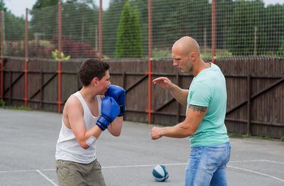 Men practicing boxing at court