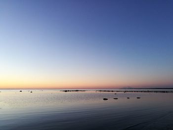 Scenic view of sea against clear sky at sunset