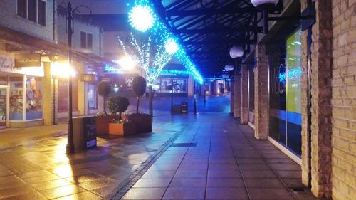 Empty illuminated street at night