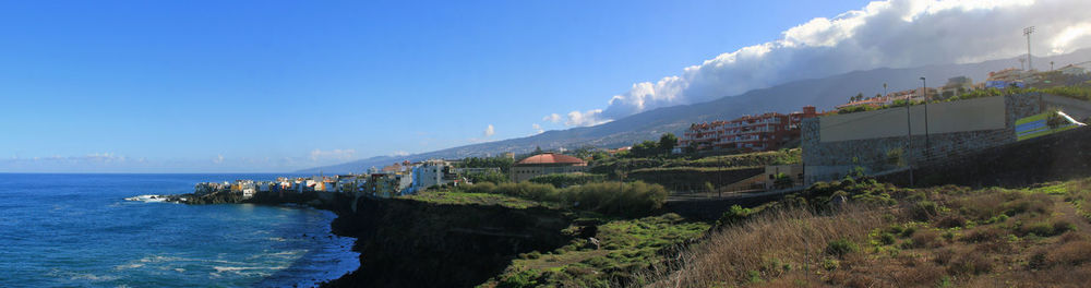 Panoramic view of sea against blue sky