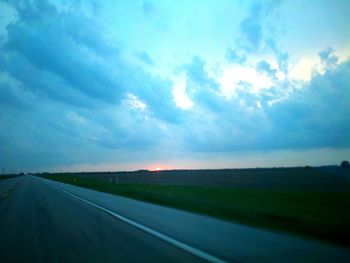 Road by landscape against sky