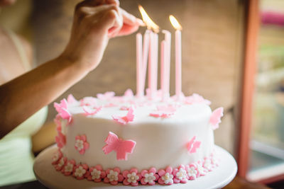 Close-up of hand holding cake