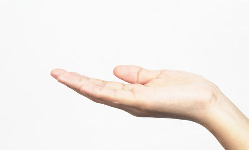 Close-up of human hand over white background