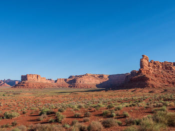 Landscape of orange and red buttes and monoliths at valley of the gods in utah