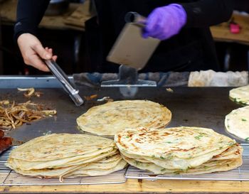 Midsection of woman preparing flat breads