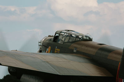 Close-up of airplane flying against sky