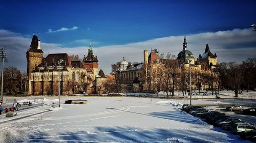 Buildings in city against sky during winter