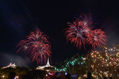 Low angle view of firework display at night