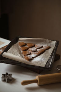 Shape of the christmas tree is made of gingerbread and powdered with sugar