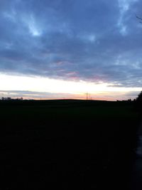 Silhouette of landscape against cloudy sky