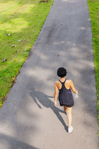 Rear view woman exercise walking in the park.