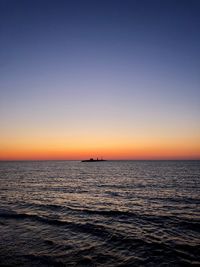 Scenic view of sea against clear sky during sunset