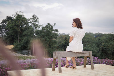 Portrait of young woman sitting on bench