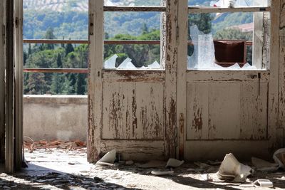 Abandoned building seen through broken window