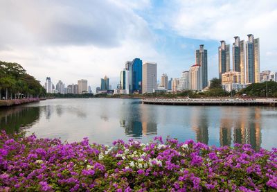 View of cityscape against cloudy sky