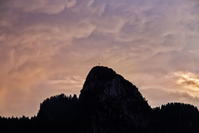 Low angle view of silhouette trees against sky