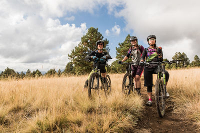 Mountain bike friends resting while on meadow trail