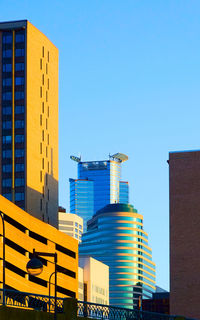 Low angle view of buildings against clear blue sky