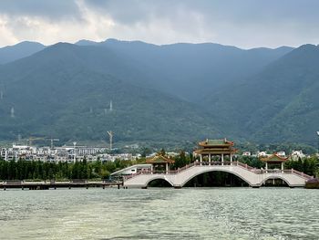 Bridge over mountains against sky