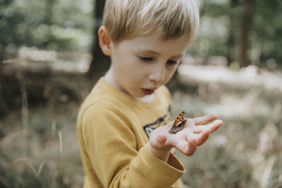 Close-up of boy holding camera