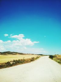 Country road passing through field