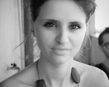 Close-up portrait of smiling young woman