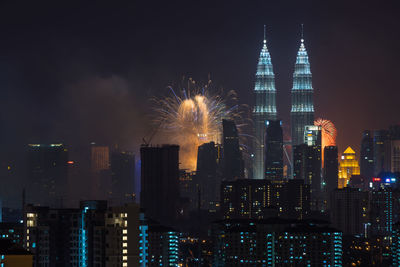 View of skyscrapers lit up at night