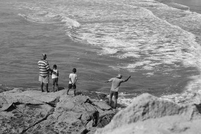 People standing on beach by sea