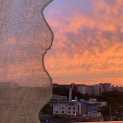 Low angle view of buildings against sky at sunset