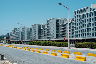 Street and buildings against blue sky