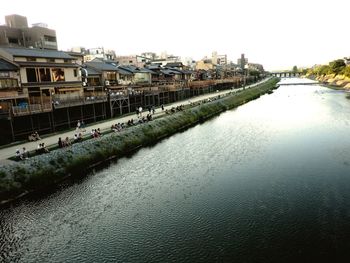 River amidst buildings against clear sky