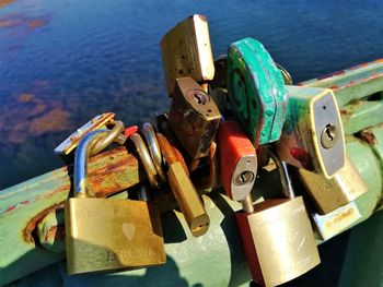 Close-up of padlocks on bridge over river