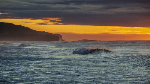 Scenic view of sea against sky during sunrise 